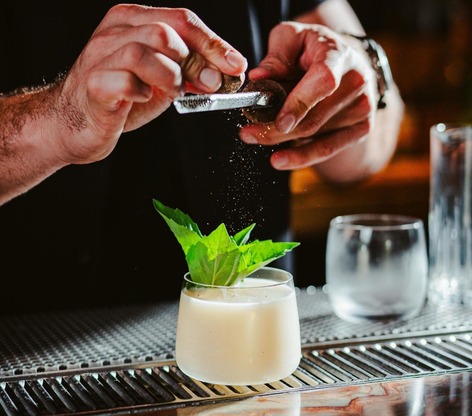 Vignette Collection Yours Truly Dc By Ihg Washington Kültér fotó A bartender grating nutmeg over a cocktail